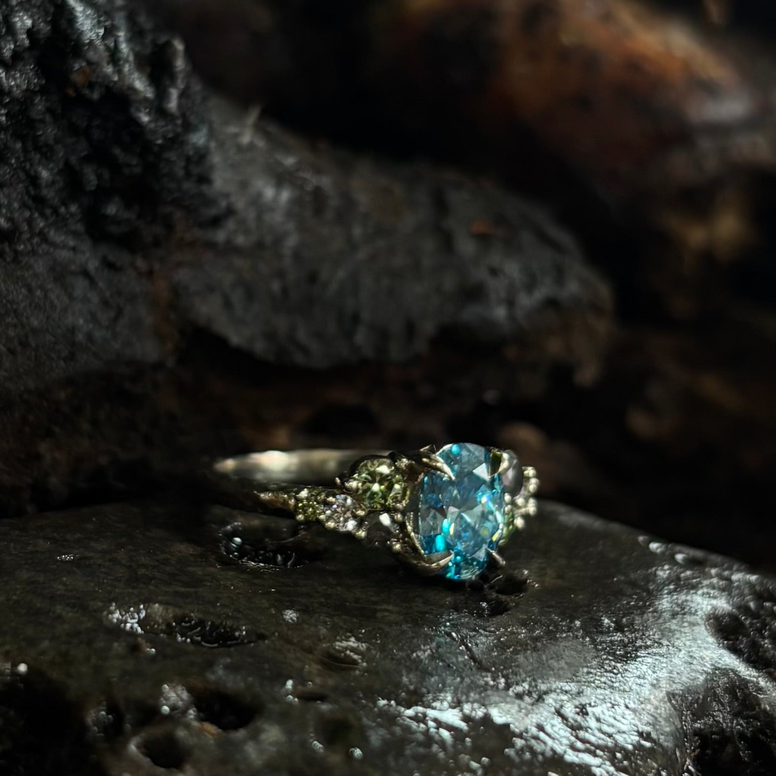 Ring with a blue gemstone on a dark textured surface